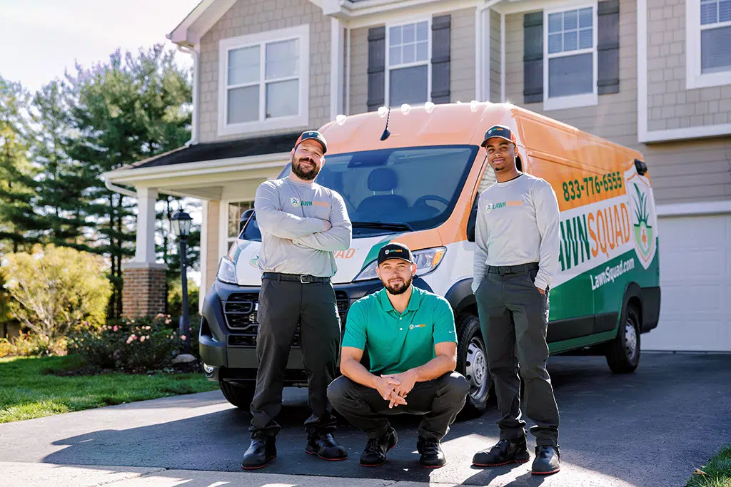 The Lawn Squad of North Atlanta team in front of their service van
